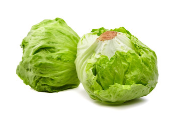 Fototapeta premium Iceberg lettuce isolated on white background. Two whole heads of crisphead lettuce, leafy green vegetables
