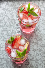 Pink lemonade with lemon and strawberries 