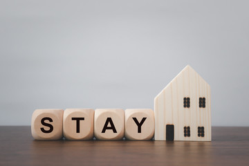 Stay home safely. Message on wooden dice. Coronavirus Outbreak (Covid 19)