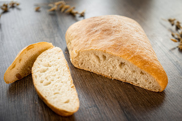 Fresh bakery, sliced bread on a wooden backround