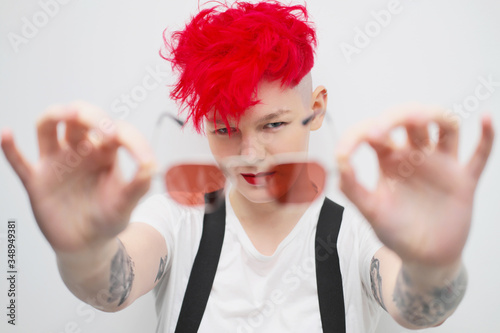 Portrait Of A Cool Fashionable Modern Young Girl A Short Haircut With Shaved Temple Dyed Bright Red Hair Red Lipstick Studio Photo On White Background Suspenders And Checkered Pants Attractive Wall Mural Portrait Of A Cool Fashionable Modern Young Girl A Short Haircut With Shaved Temple Dyed Bright Red Hair Red Lipstick Studio Photo On White Background Suspenders And Checkered Pants Attractive Wall Mural