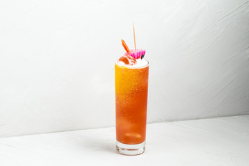 Fresh fruit yellow alcohol cocktail in a highball 