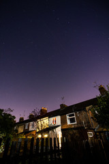 beautiful night sky behind row of terrace houses