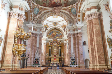 Fototapeta na wymiar St. James Cathedral in Innsbruck, Austria - Benches, Altar and Columns