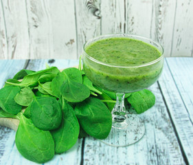 Fresh green spinach smoothie on a wooden background. Healthy lifestyle.                              Organic food.