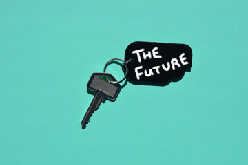 Key and tag with the words The Future, isolated on turquoise background