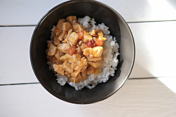 Sweet and Sour Chicken with pineapple and bamboo served with steamed rice. caribbean style chicken. traditional delicious meal.