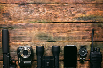 Spy secret service agent equipment on the wooden table background.
