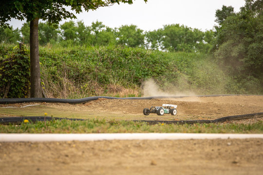 Offroad RC buggy driving on an outdoor dirt track