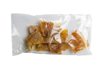 Dried catfish fillet in a transparent package appetizer to beer on wooden background. Snack Fish to...