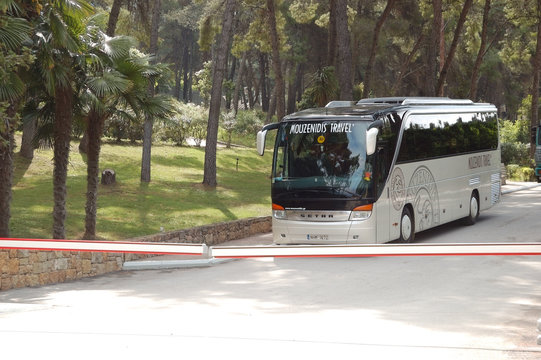 KASSANDRA PENINSULA, GREECE - APRIL 28: The modern bus for tourists transportation is near entrance to hotel on April 28, 2012 in Kassandra peninsula, Greece. 