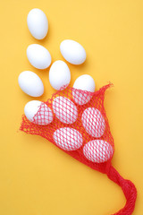 Eggs,Eggs come out of the net red bag.top view yellow background ,easter egg
