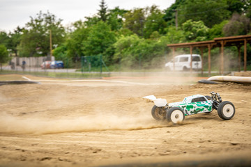 Offroad RC buggy driving on an outdoor dirt track