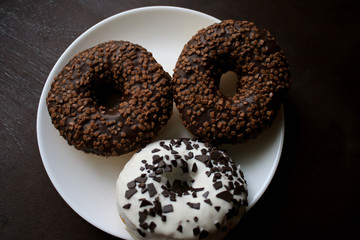 Chocolate donuts on a white plate