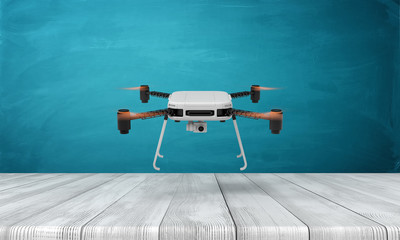 3d rendering of flying drone over white wooden floor and dark turquoise background