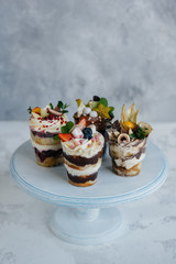 Set of beautiful delicious trifl close - up on the background. Dessert and sweets