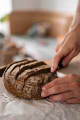hand holding a loaf of bread