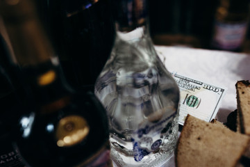 bottles dollars money table alcohol vodka