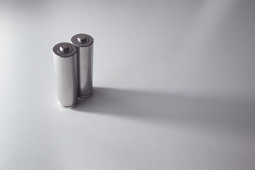 Two aa gray batteries on a white background