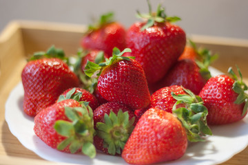 Fresh ripe strawberries in a white plate
