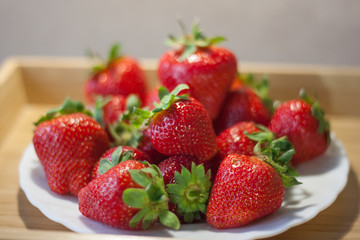 Fresh ripe strawberries in a white plate