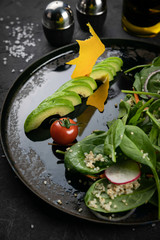 A fresh, healthy salad with zoodles zucchini noodles, baby tomatoes, avocado