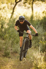 Cyclist man riding mountain bike on a mountain.