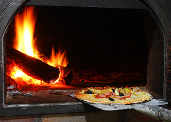 Handmade pizza in wooden oven