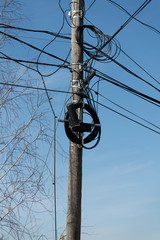 Wooden electric pole with lots of wires.