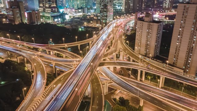 Hyper lapse Rising Drone Shot View Reveals Spectacular Elevated Highway and Convergence of Roads, Bridges, Viaducts in Shanghai Night, Transportation and Infrastructure Development in China Timelapse.