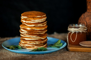 Appetizing domestic pancakes with maple syrup at rustic  style