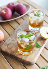 Close up glass with refreshment apple juice with ice