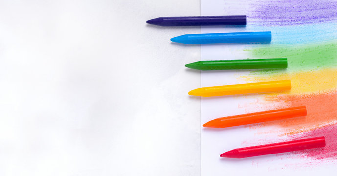The concept of drawing lessons. Crayons of different colors on a white background. Copy space