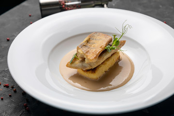 Fish grill on white plate in restaurant