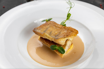Fish grill on white plate in restaurant