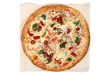 Hot pizza on parchment paper. Tasty pizza with cheese, sausage, jalapenos and tomatoes on a white background. Top view..
