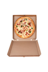 Hot Pizza in an open cardboard box. Tasty pizza with cheese, sausage, jalapenos and tomatoes on a white background. Top view.