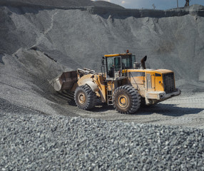 Front-end loader in a limestone quarry, close-up.