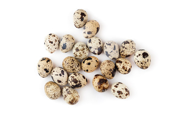 Quail eggs on a white background. Several quail eggs close-up on a white background. Top view.