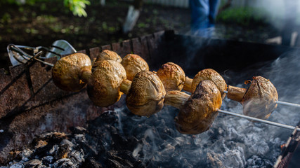 Appetizing mushrooms are grilled. Vegan shish kebab.