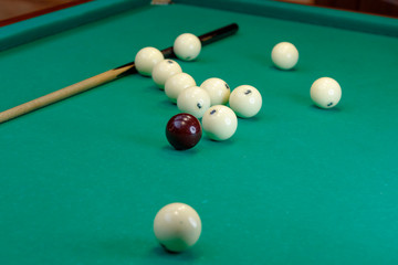 billiard table with balls and cue