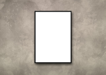 Black picture frame hanging on a light concrete wall