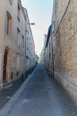 Fototapeta na wymiar Old buildings and narrow street in Caen, Normandy, France