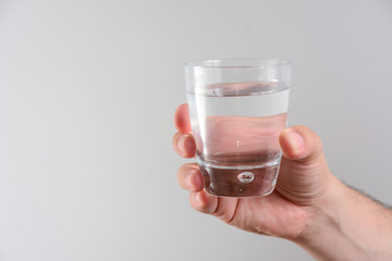 Hand hold a glass of water on white backgrounds, isolated