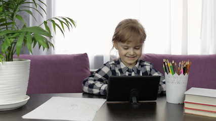 Fototapeta na wymiar Girl learning online lessons using digital tablet computer. Distance education