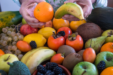 Different kind of fresh fruits in orange, yellow and green colors. Healthy eating concept and detox diet. Vegan and vegetarian food.