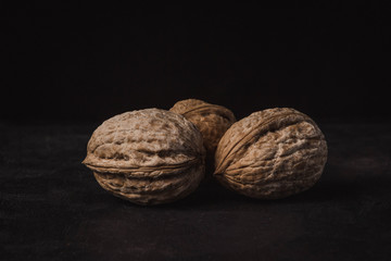three nuts on a black background