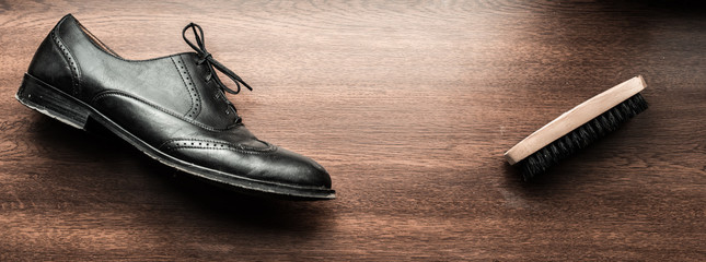 black shoes and a cleaning brush