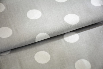 Grey polka dot fabric sample. Fabric background