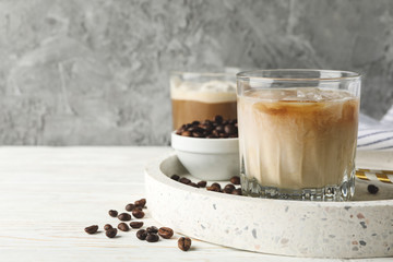 Composition with tray with ice coffee on wooden background